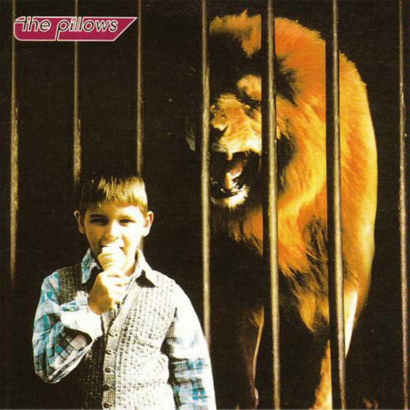 the pillows LITTLE BUSTERS album cover art. It features a little boy eating an ice cream in front of a lion in a cage.