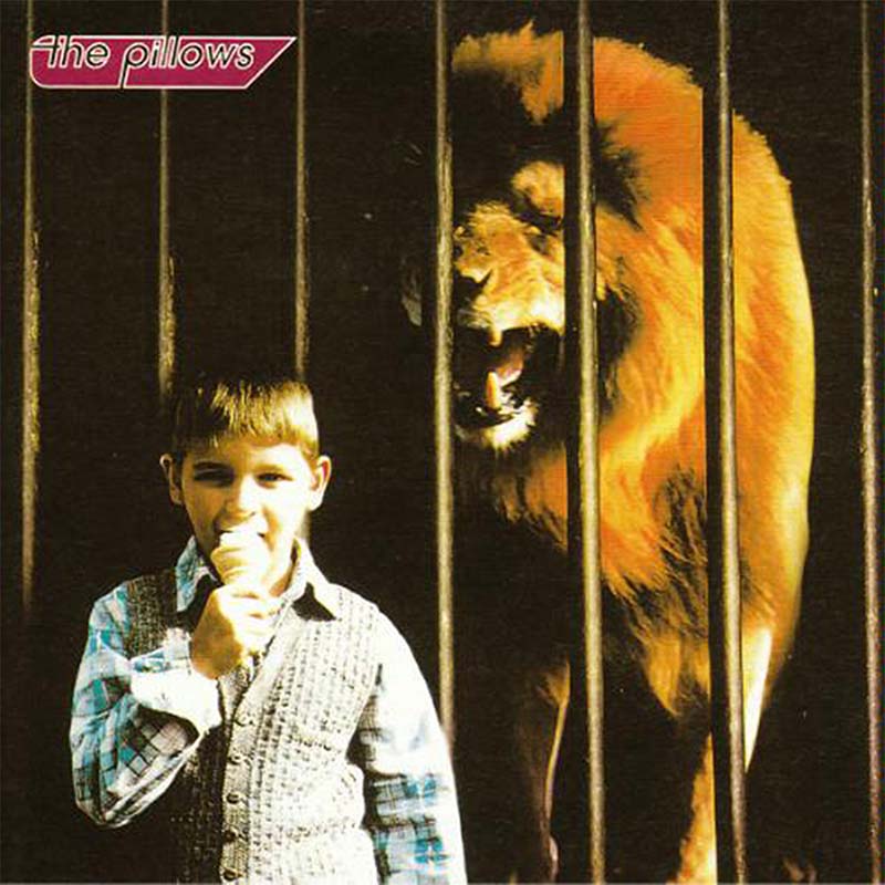 the pillows LITTLE BUSTERS album cover art. It features a little boy eating an ice cream in front of a lion in a cage.